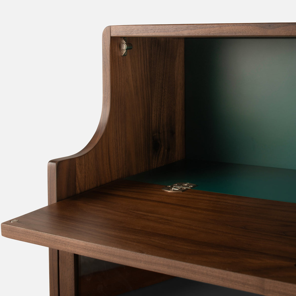Close-up view of Peggy Cabinet showcasing open door, hinges, and green interior against a light background