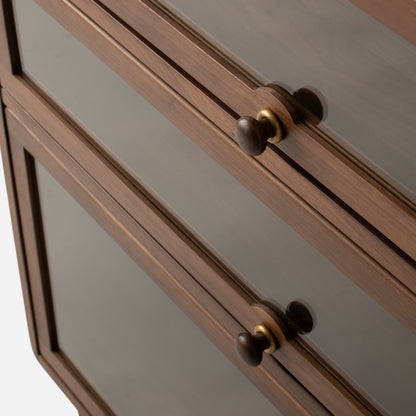Close-up angled view of Peggy Cabinet showcasing framed inset panels, round knobs, and decorative trim on a plain background