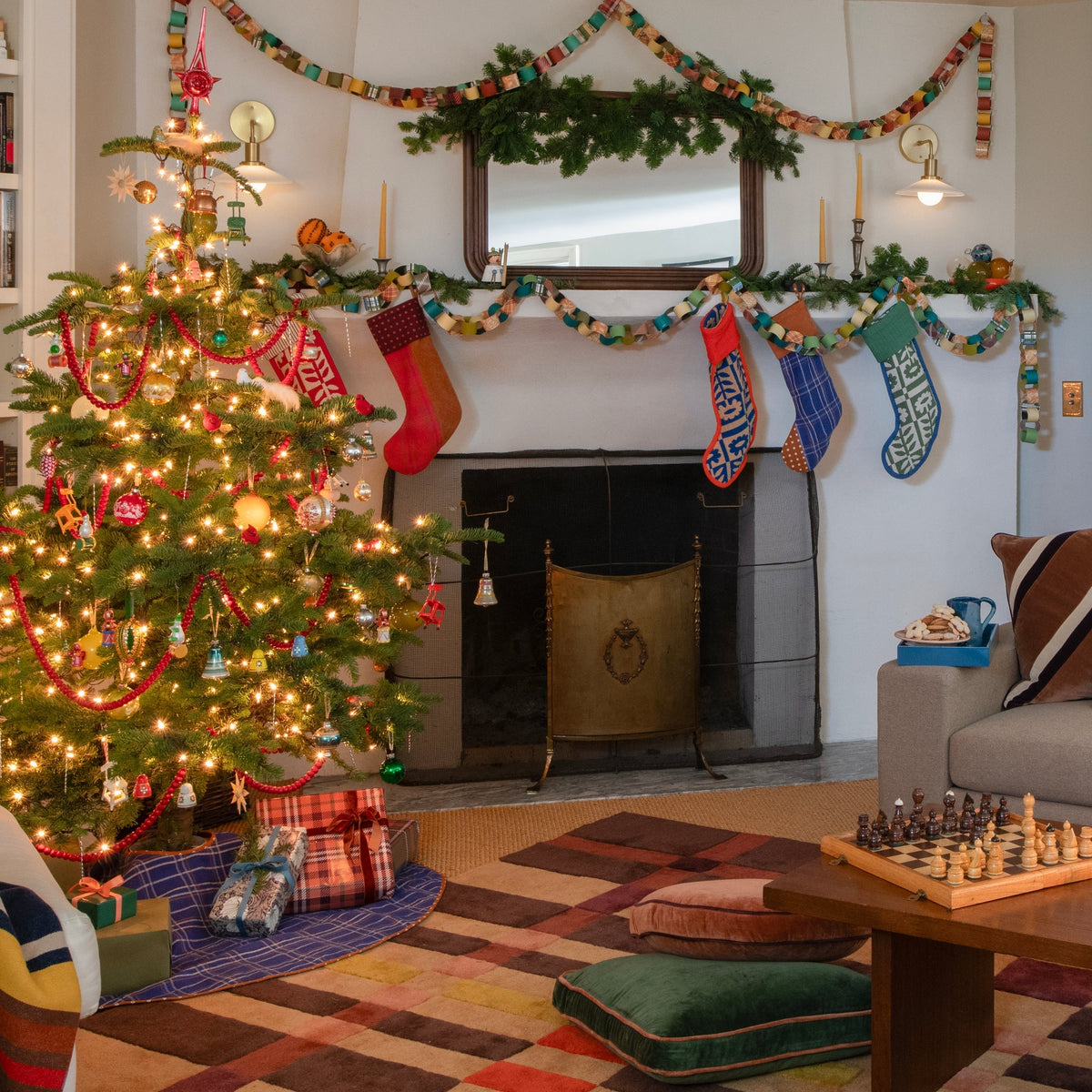 Cobalt Haberdasher’s Tree Skirt beneath a decorated Christmas tree in a festive living room