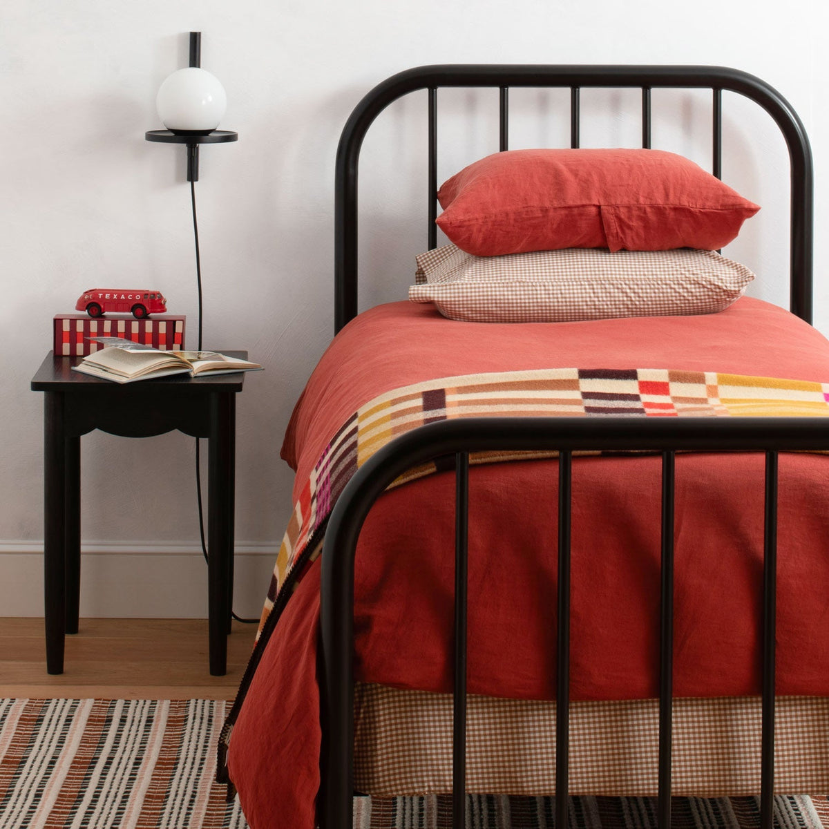 Front view of Gingham Pillowcase showcasing its gingham pattern on a bed in a bedroom
