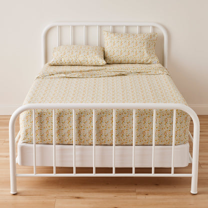 Front view of Wallowa Floral Pillowcase showcasing a multicolor floral pattern on a made bed
