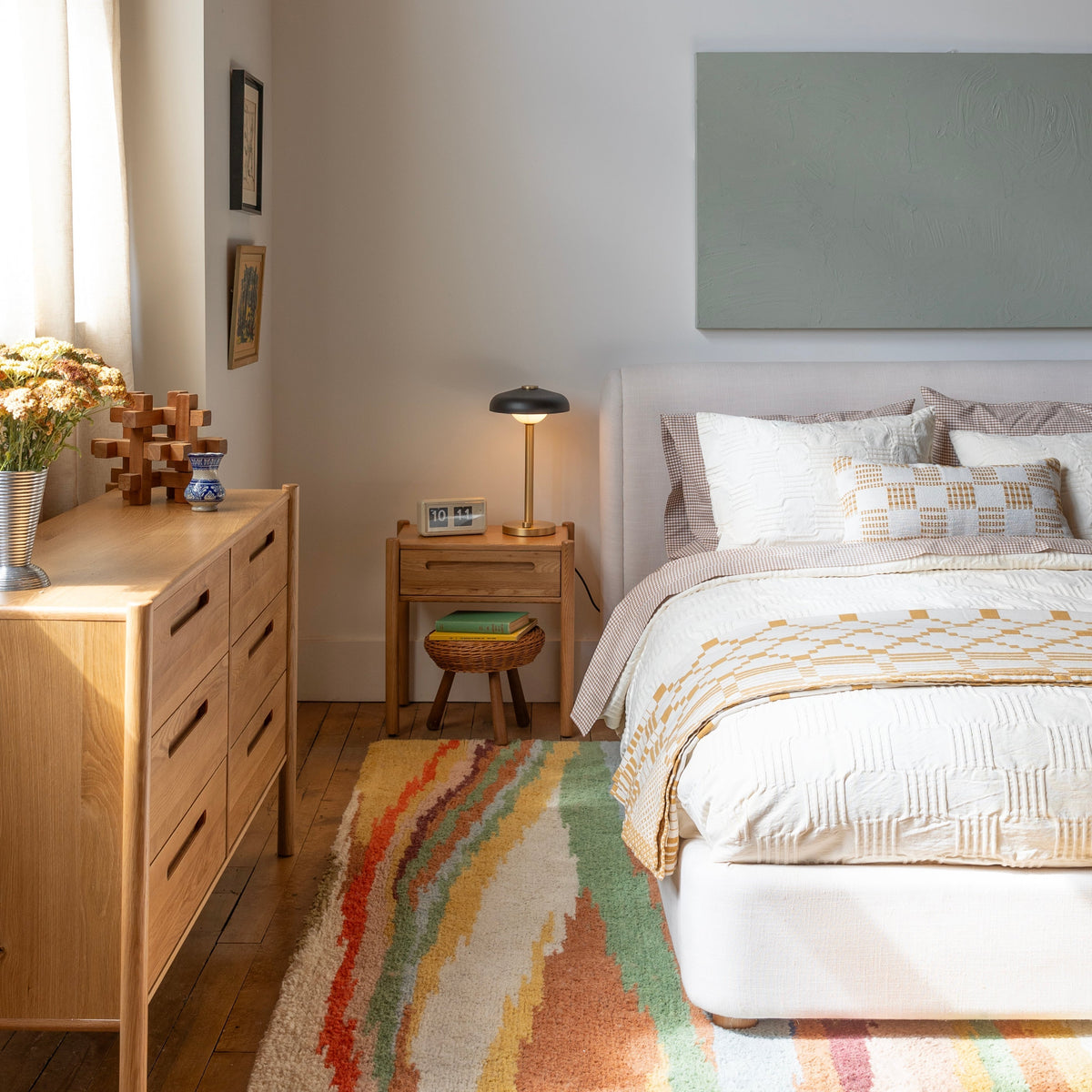 Angled view of Nora 6-Drawer Dresser showcasing six drawers and pill-shaped handles with a sunlit bedroom background