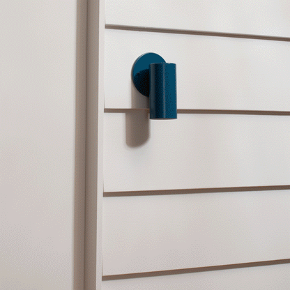Side view of Eduard Wall Sconce showcasing its closed top on a white paneled wall