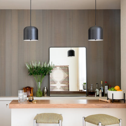 Leo Mirror above a home bar with pendant lights, flowers, drinks, and fruit