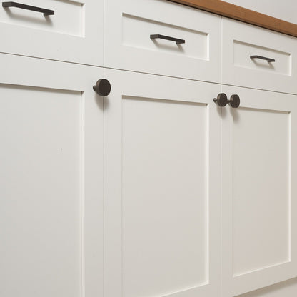 Greenwood pulls installed on white paneled cabinetry in a contemporary kitchen