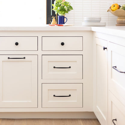Somerset Knob accents cream kitchen cabinetry in a bright, modern kitchen