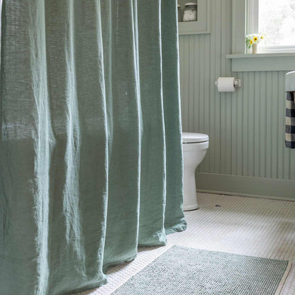 Front view of Laurel linen shower curtain showcasing its lived-in texture in a bright bathroom