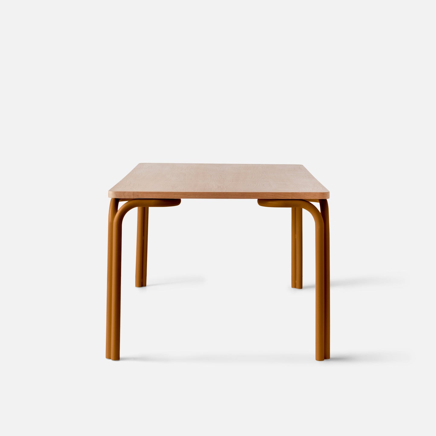 Front view of Forma Dining Table showcasing light oak tabletop and curved rust-colored tubular legs on white background