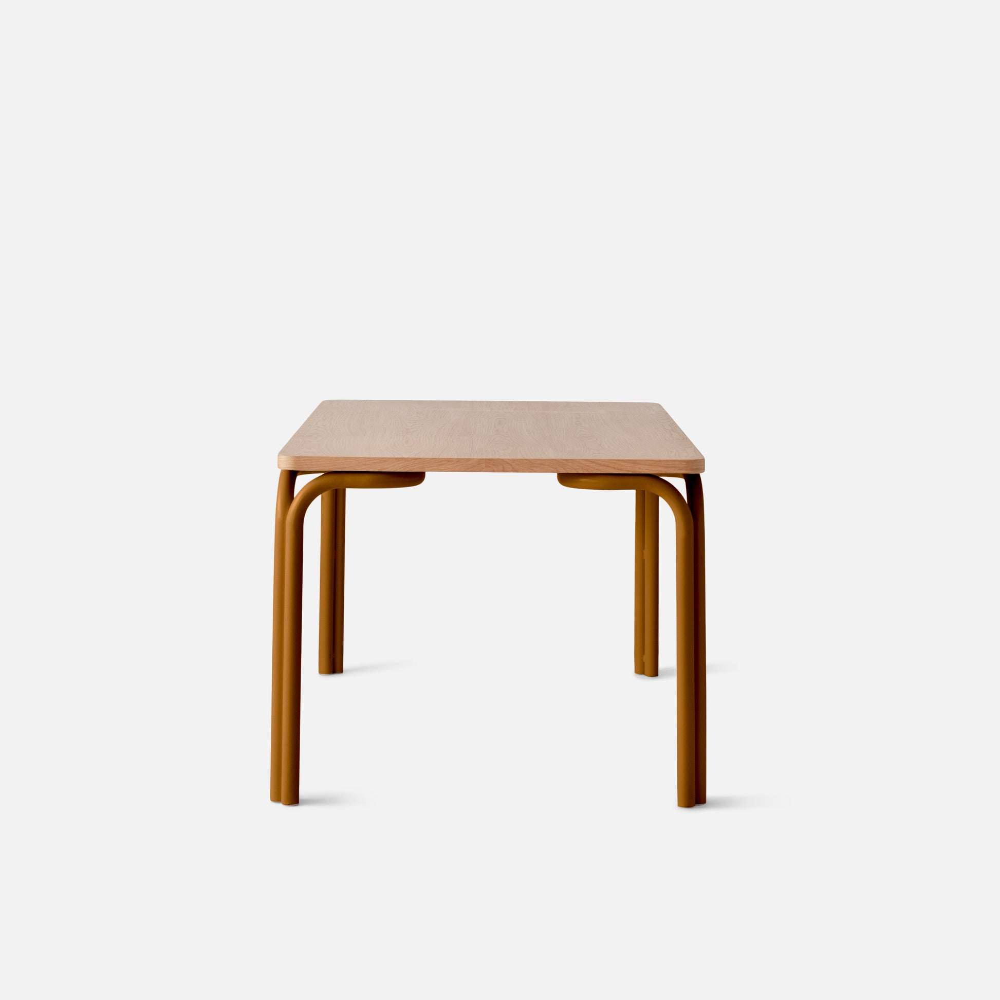 Front view of Forma Dining Table showcasing light oak rectangular top and mustard-colored tubular metal legs on white background