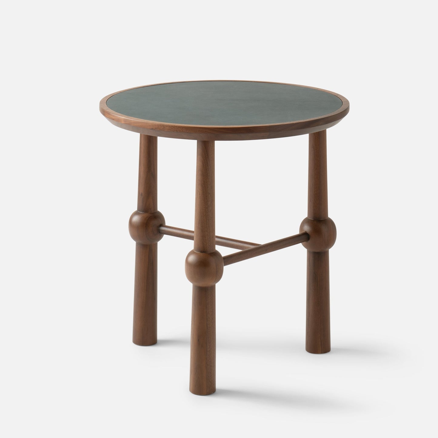 Three-quarter view of Ann Occasional Table showing walnut legs with rounded joints and a dark green leather top on white