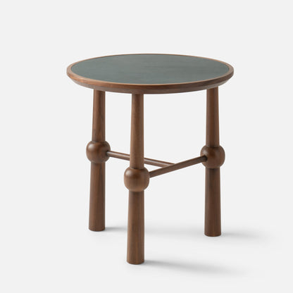Three-quarter view of Ann Occasional Table showing walnut legs with rounded joints and a dark green leather top on white