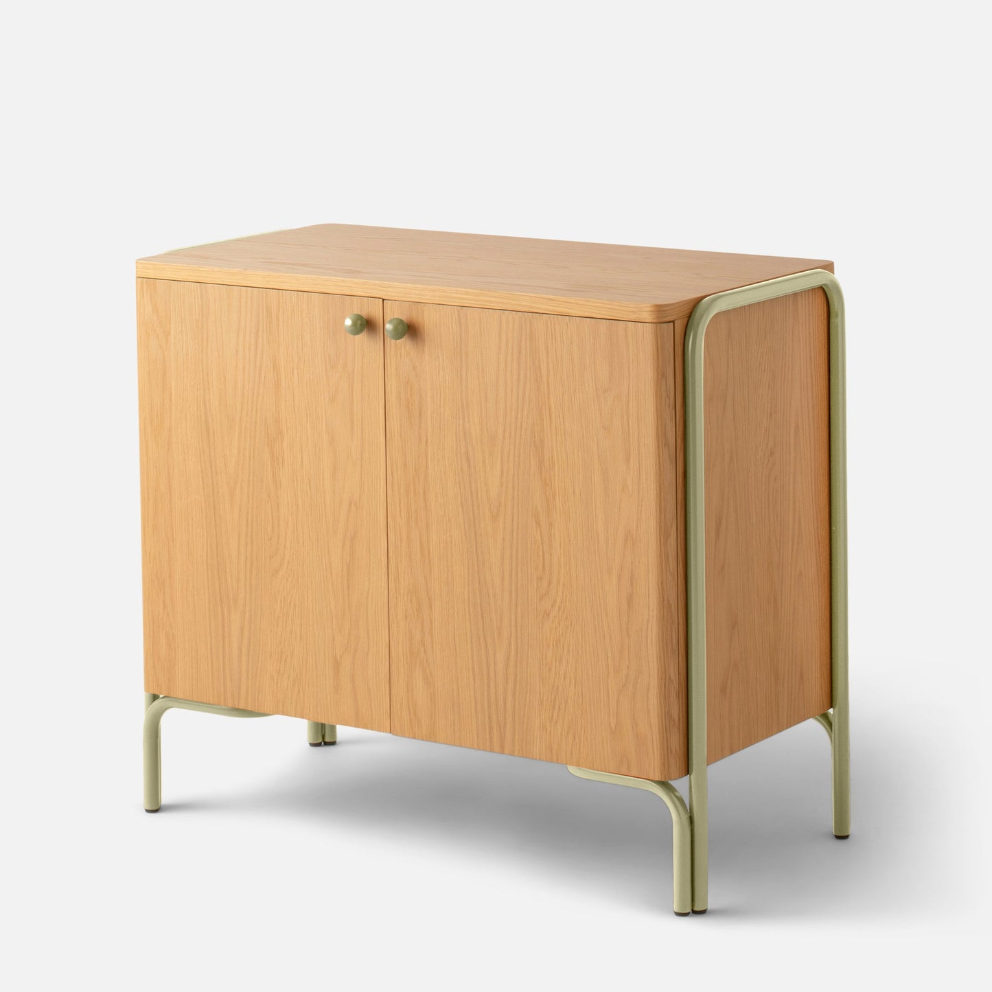 Angled view of Forma Cabinet showing oak-veneer doors, round green knobs, and powder-coated green steel legs on a white background