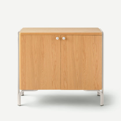 Front view of Forma Cabinet showing natural oak double doors, white round knobs, and white metal frame on white background