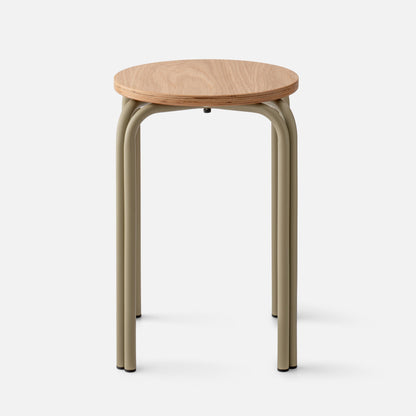 Front view of Forma Stool showcasing round white oak top with exposed plywood edge and matte olive steel legs on light background