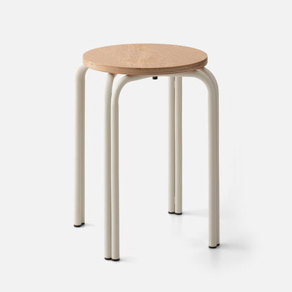 Close-up front view of Forma Stool showing round plywood seat and cream tubular metal legs on white background