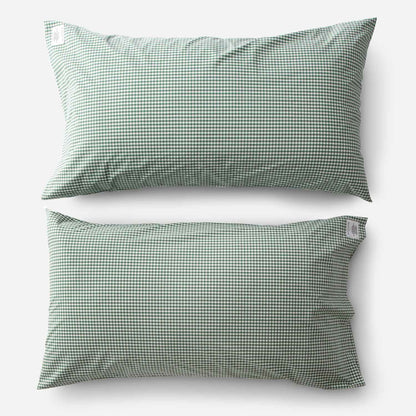Top-down view of Gingham percale pillowcase set showcasing juniper green gingham check on white background