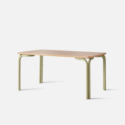 Front view of Forma Dining Table showcasing light wood top and sage-green rounded metal legs on white background