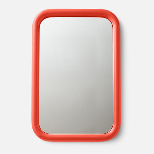 Front view of Forma rectangular mirror showcasing rounded coral red frame against light gray background
